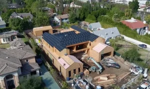 Aerial view of new construction home with roof installation in progress by Confirmed Roofing Experts in Malibu, California
